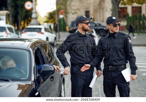 Police officer\
takes a bribe from a female\
driver