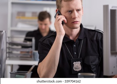 Police officer is talking on mobile phone