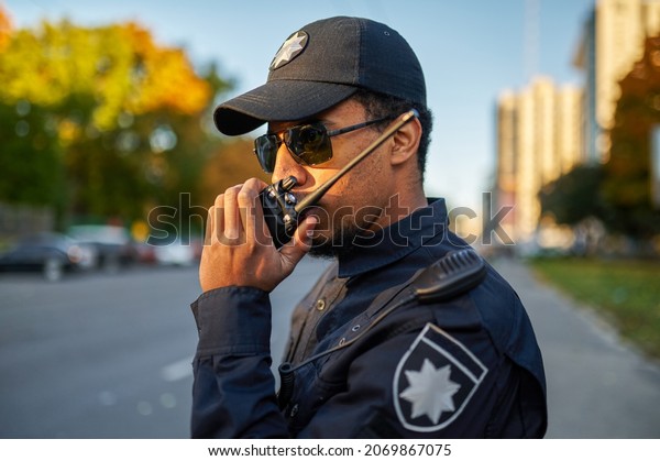 Police officer talking on\
the radio