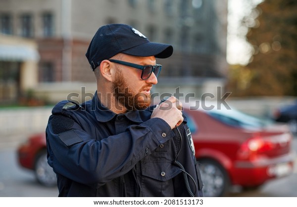 Police officer\
talking on the radio, car\
parking