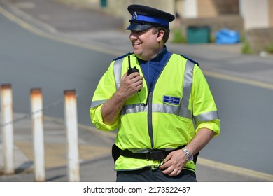 A Police Officer Talks On A Radio While Standing Guard At A Roadblock After An Incident In The City Centre On May 13, 2016 In Bath, UK. Emergency Services Responded To Reports Of An Unexploded Bomb.