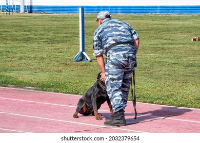 A Police Officer Training A Sniff Dog For Finding Drugs, Weapons, Explosives.