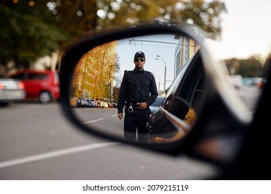 Police Officer, View Through Car Rear View Mirror