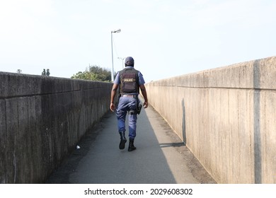 Police Officer Walking On A Bridge