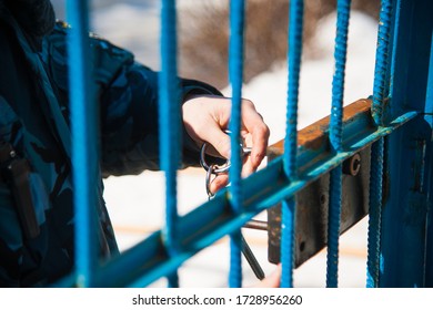 Police Officers Locks The Door In Prison Corridor