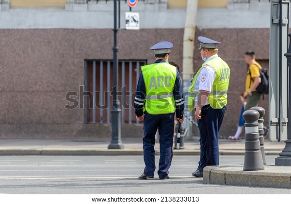 Police officers of road guard service standing at\
crossroads, controlling movement of cars, conducting raid. St.\
Petersburg, Russia 2021 June\
05