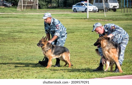 Police Officers Training A Sniff Dog For Finding Drugs, Weapons, Explosives: Abakan, Russia - August 21, 2018