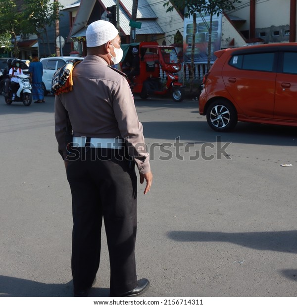 The police on duty on Eid Al-Fitr 1443 Hijriyah in\
Gowa, South Sulawesi, wore uniforms with additional Muslim\
attributes in the form of a skullcap and prayer rug. Taken on May\
2, 2022