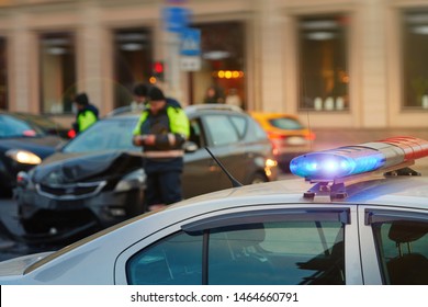 Police Patrol Cars With Red And Blue Flashing Siren On The Road.  Automobile Collision On The Road. Investigating Car Accident, Road Crash. Police Officer On Background. Police Vehicle