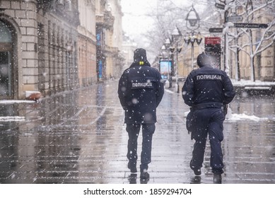 Police patrolling and walking trough empty streets on snowy day in Belgrade,Serbia during police hour due to corona virus covid-19
Translation: "Police. " - Powered by Shutterstock