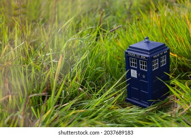 Police Public Call Box On Green Grass. Blue Police Box From London As Doctor Who Tardis. Time And Space Machine In Miniature. Time Travel.