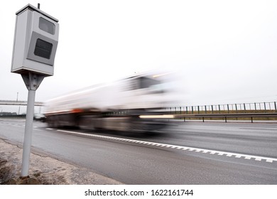 Police radar for measuring speed of passing vehicles stands on highway. Radar installed on roadside to control speed limit. Speed control, radar on the sideline controls speed of moving cars