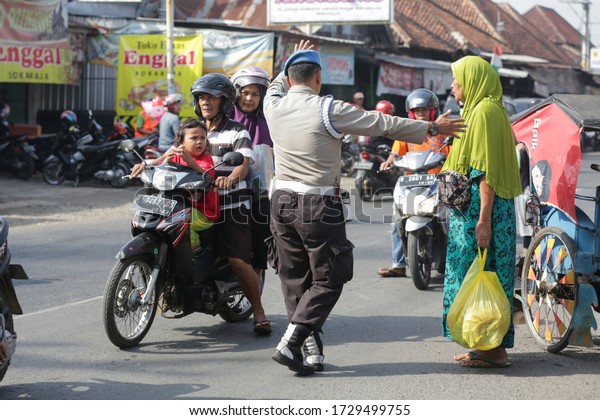 The police regulate the traffic going home ( mudik )
ahead of Eid Al-Fitr in Sokaraja, Purwokerto, Central Java,
Indonesia. June 4, 2019