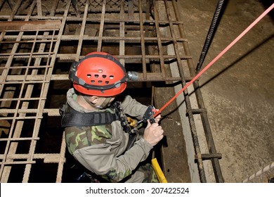 Police Rescue Worker Runs The Rope Into The Flooded Old Mine