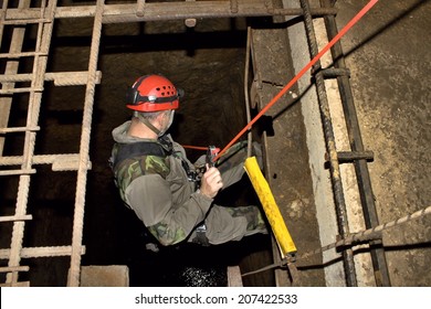 Police Rescue Worker Runs The Rope Into The Flooded Old Mine