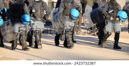 police in riot gear during the protest demonstration with helmets on the road