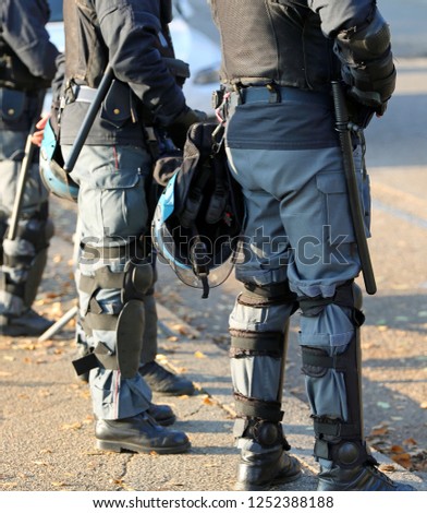 police in riot gear with protective helmet during the urban revolt of the protesters
