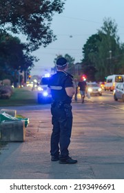 Police Sergeant At Duty On The Street At Evening