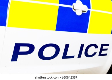 Police Sign On Bottom Of Surrey Police Car Door. Horizontal Low Angle Perspective