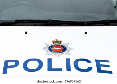 Police Sign On Top Of Surrey Police Car Hood. Horizontal Low Angle Perspective Close Up. Surrey Police Car Identification, July 2017