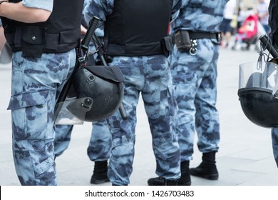 Police Squad With Helmets, Body Armor And Batons Close-up