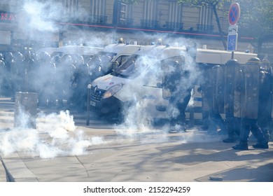 Police stand in formation amidst tear gas smoke during clashes with protesters on the sidelines of the annual May Day (Labour Day) rally, marking International Workers' Day, in Paris on May 1, 2022. 
