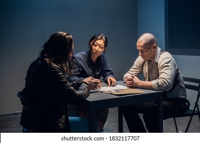 In The Police Station's Interrogation Room, Good And Bad Cops Are Questioning A Theft Suspect In A Leather Jacket