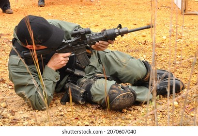 Police SWAT Officer Takes Aim With Rifle.