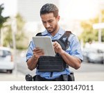 Police, tablet and patrol with a man officer outdoor on the street, using the internet to search during an investigation. Technology, information or law enforcement with a male security guard on duty