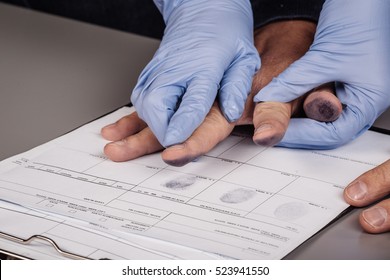 Police Takes Fingerprints Of A Criminal. Law Concept.