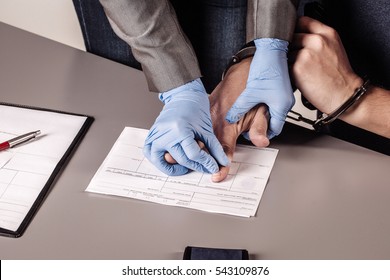police takes fingerprints of a criminal. law concept.