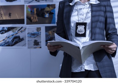 Police Woman Is Reviewing Files And Documents