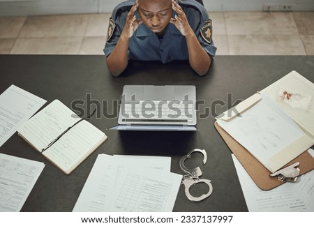 Police, woman and working with stress at desk with documents, paperwork or frustrated with headache from working on computer case, report. Security, officer and tired from work in office or station