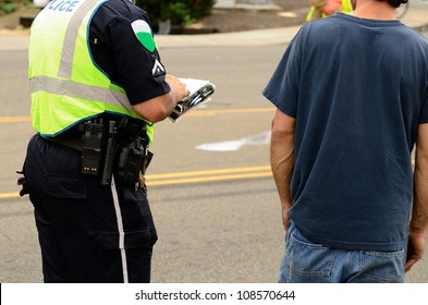 Police Writing A Citation At A Four Vehicle Accident Involving Two Large Trucks Resulted In A Single Injury And A Diesel Fuel Spill. July 17, 2012 In Roseburg Oregon