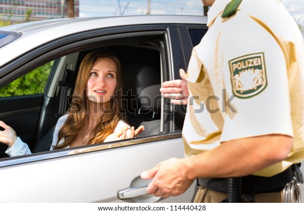 Police - young woman with policeman or cop on the\
street or traffic