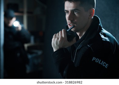 Policeman at action talking on walkie talkie - Powered by Shutterstock