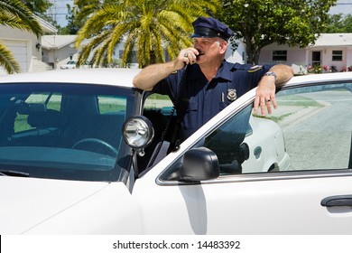 Policeman calls headquarters on his two way radio. - Powered by Shutterstock