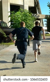 Policeman Chasing After Running Away Suspect Man