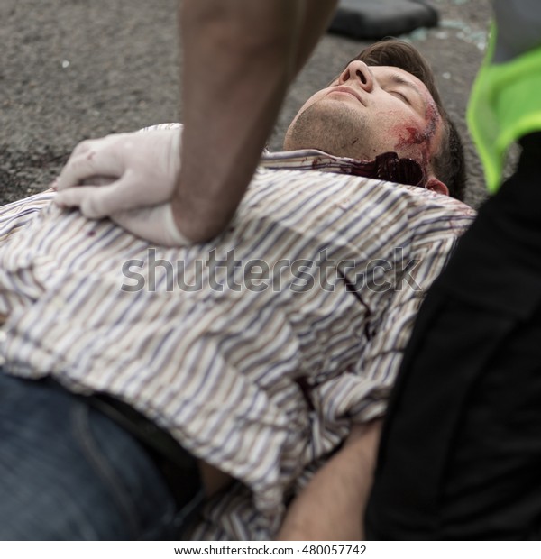 Policeman doing\
chest compression to injured\
man