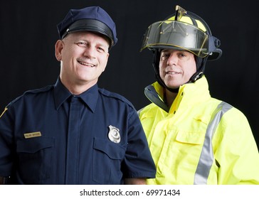 Policeman And Fireman Both Photographed Against A Black Background.