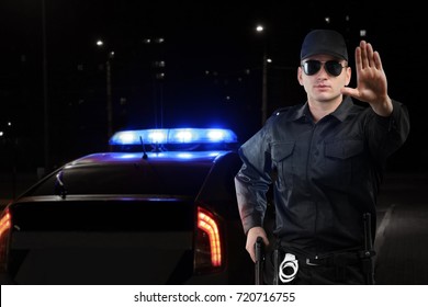 Policeman Near Car Outdoors At Night
