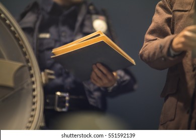 Policeman Is Reviewing Files And Documents