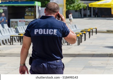 Policeman Talking On Phone Outdoor Police Security