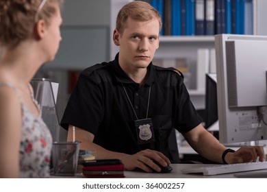 Policeman Talking With Young Woman On Police Station