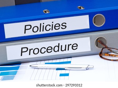 Policies And Procedure - Two Binders On Desk In The Office