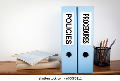 Policies and Procedures binders in the office. Stationery on a wooden shelf - Shutterstock ID 670090111