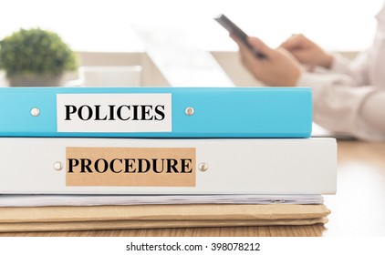 Policies And Procedures Doucument Place On Desk In Meeting Room.  Policy, Procedure Concept.