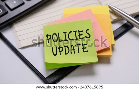 Policies Update Memo Written on a Notebook With Pen, Calculator and Book.
