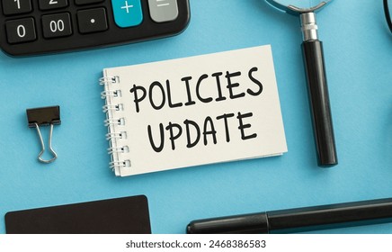 Policies Update text concept write on notebook, blue background