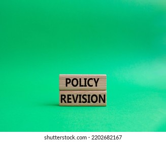 Policy Revision Symbol. Concept Word Policy Revision On Wooden Blocks. Beautiful Green Background. Business And Policy Revision Concept. Copy Space